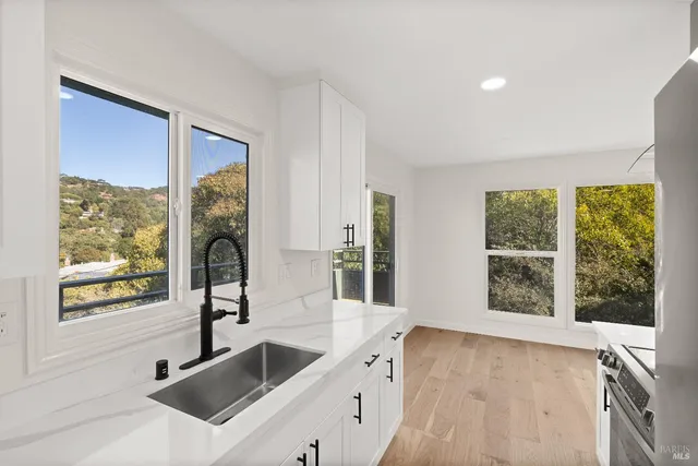 a kitchen with a sink and large window
