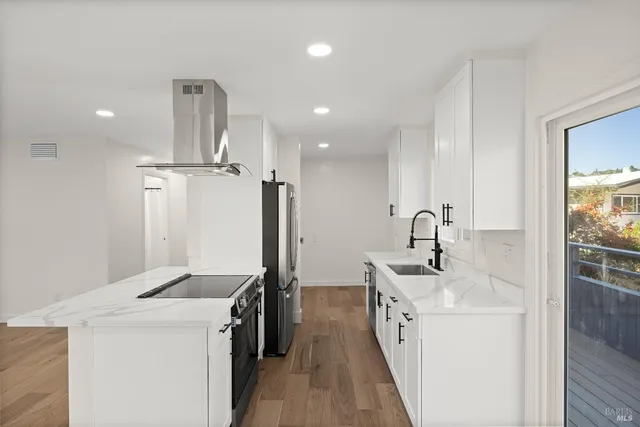 a kitchen with a sink and a refrigerator