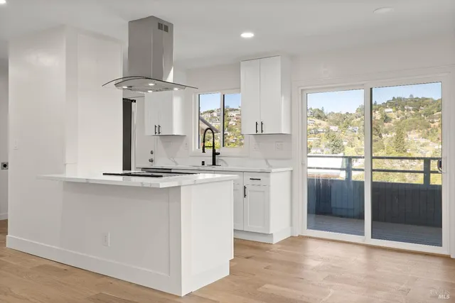 a kitchen with stainless steel appliances granite countertop a sink and a refrigerator