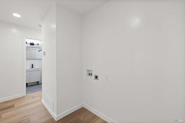 a view of a hallway with wooden floor