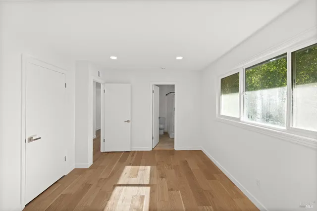 a view of a room with wooden floor and windows