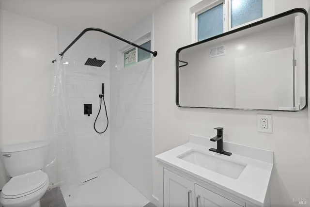 a bathroom with a sink a mirror and a shower