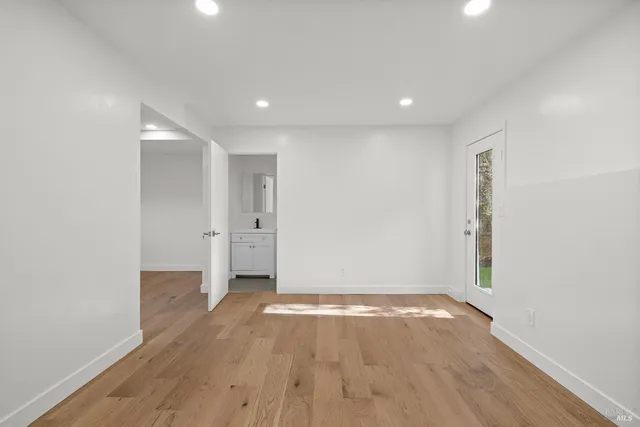 a bathroom with a toilet sink vanity and mirror
