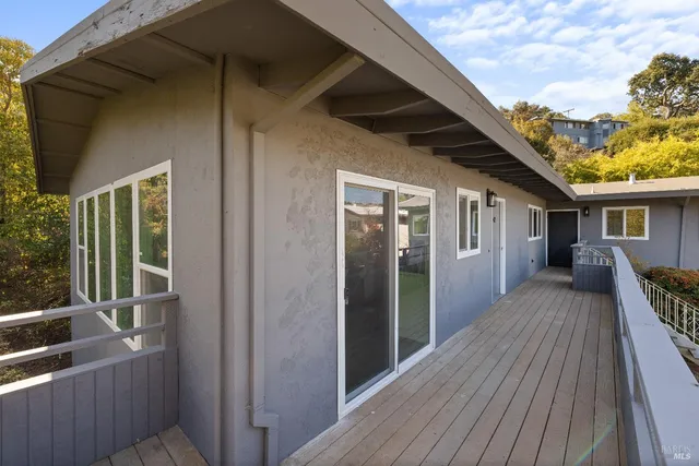 a view of balcony with wooden floor and fence