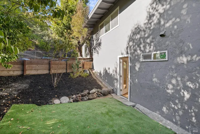a view of a house with backyard and deck