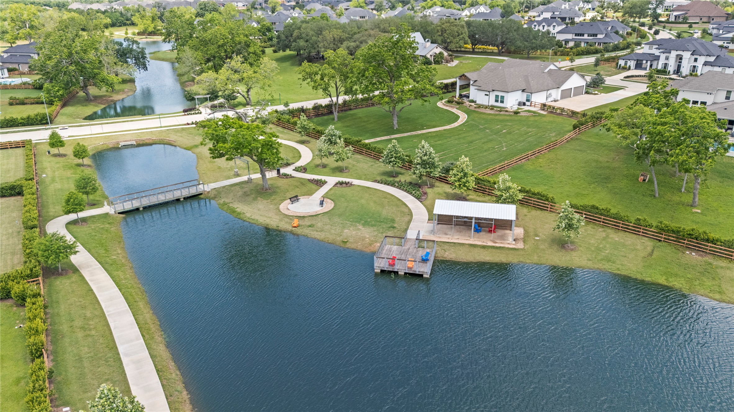 29419 Cir S Rnch Trail Fulshear, TX 77406 - Photo 44 of 45 Enjoy one of Fulshear Run’s signature gathering spaces featuring scenic lakes, walking trails, covered seating, and peaceful waterfront overlooks. Whether you're taking an evening stroll, meeting neighbors, or simply enjoying the outdoors, this thoughtfully designed amenity adds to the community’s welcoming atmosphere and connection to nature.