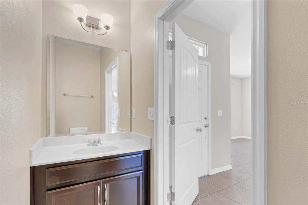 1578 Softshell Street St. Cloud, FL 34771 - Photo 15 of 27 a bathroom with a sink a vanity and a mirror
