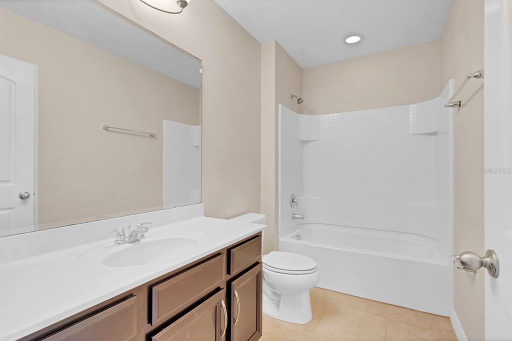 1578 Softshell Street St. Cloud, FL 34771 - Photo 24 of 27 a bathroom with a sink toilet and shower
