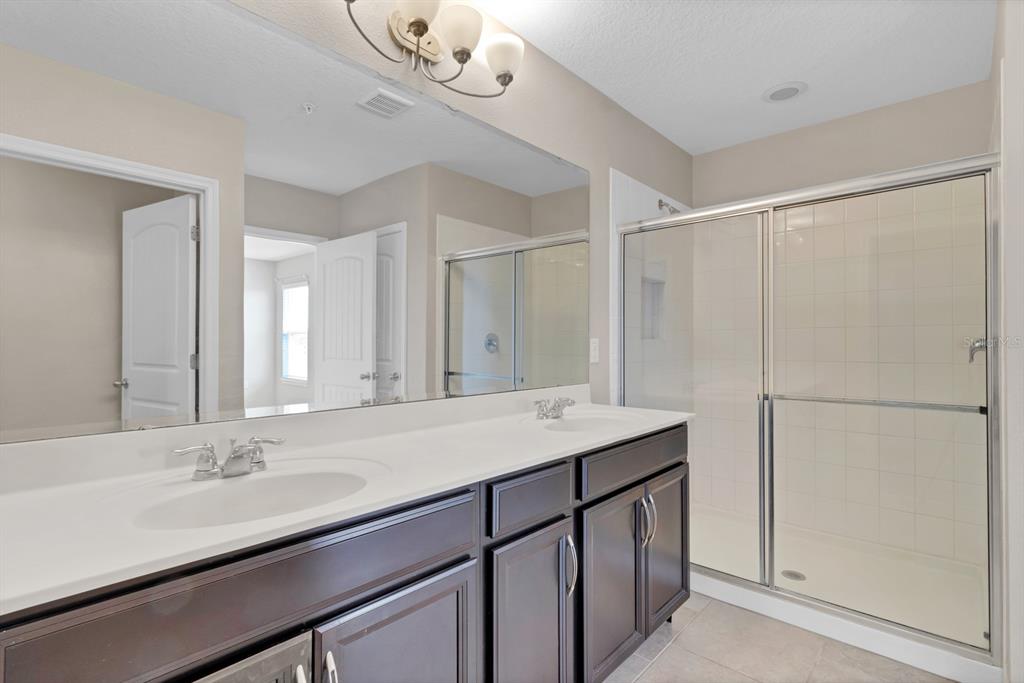 1578 Softshell Street St. Cloud, FL 34771 - Photo 26 of 27 a bathroom with a sink a shower a mirror and a vanity