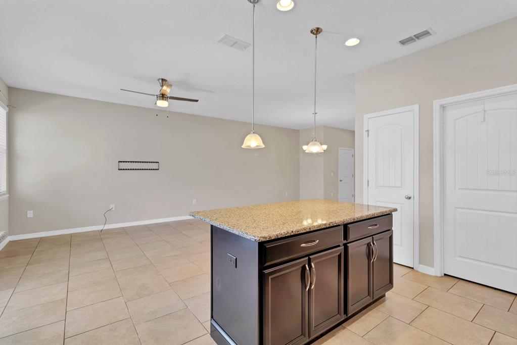 1578 Softshell Street St. Cloud, FL 34771 - Photo 6 of 27 a kitchen with a stove a sink and dishwasher