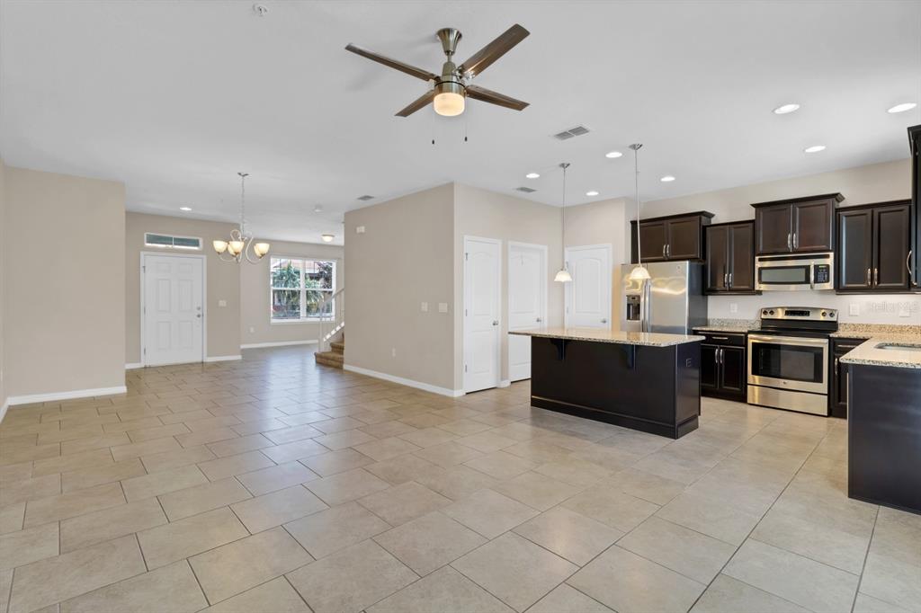 1578 Softshell Street St. Cloud, FL 34771 - Photo 10 of 27 a view of kitchen with microwave and cabinets