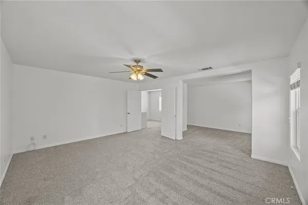 an empty room with a view of a kitchen