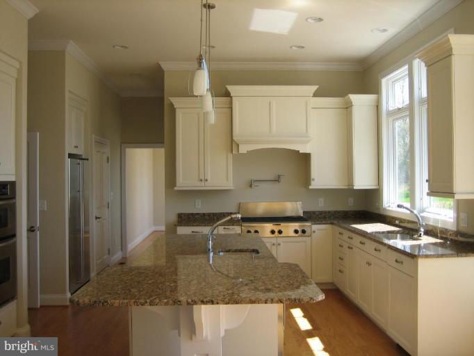 1405 Sharps Point Road Annapolis, MD 21409 - Photo 5 of 14 a kitchen with a sink stove and cabinets