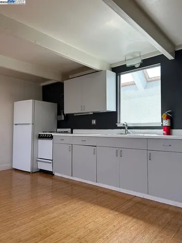a kitchen with stainless steel appliances granite countertop a sink and a stove
