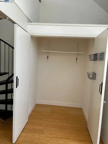 a view of a room with wooden floor and windows