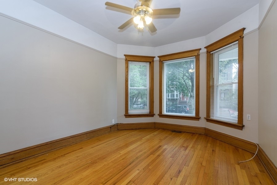 1312 West Nelson Street, Unit 1 Chicago, IL 60657 - Photo 2 of 12 a view of an empty room with wooden floor and a window