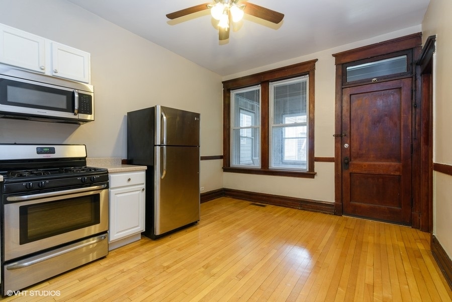 1312 West Nelson Street, Unit 1 Chicago, IL 60657 - Photo 5 of 12 a kitchen with a stove and a refrigerator