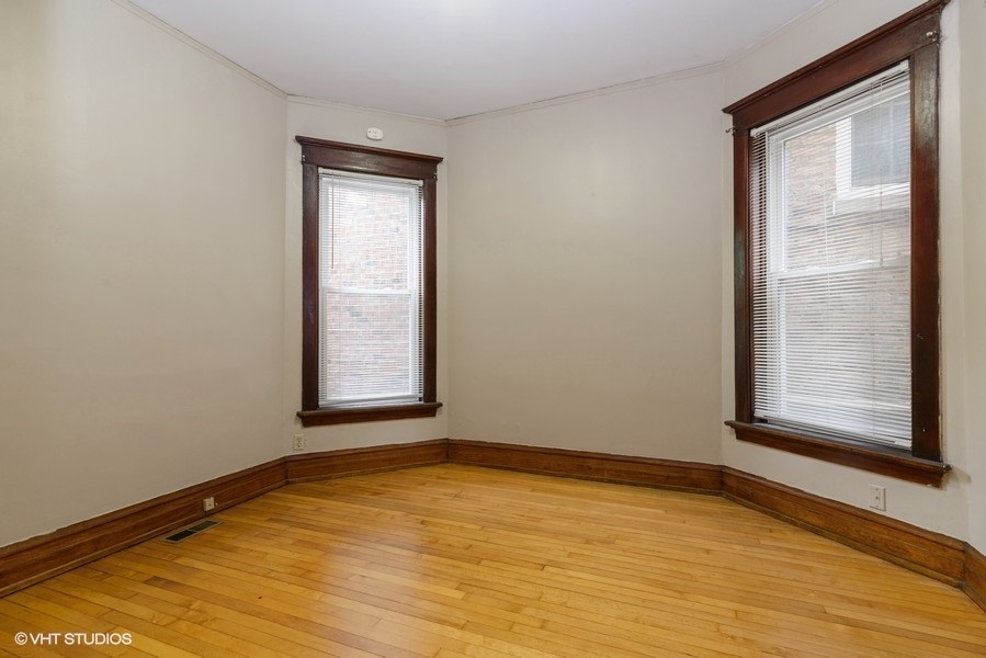 1312 West Nelson Street, Unit 1 Chicago, IL 60657 - Photo 9 of 12 a view of an empty room with wooden floor and a window