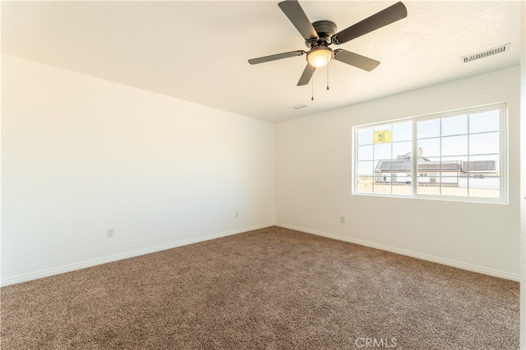 16925 Nanticoke Road Apple Valley, CA 92307 - Photo 73 of 87 an empty room with a window and a fan