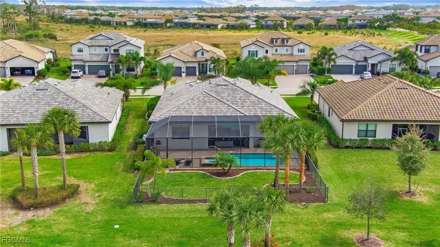 an aerial view of a house with a garden and lake view