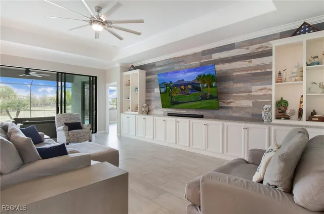 a living room with furniture a flat screen tv and a large window