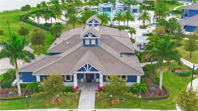 a front view of a house with a yard and potted plants