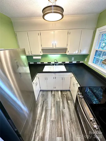 a view of a kitchen with a sink and dishwasher