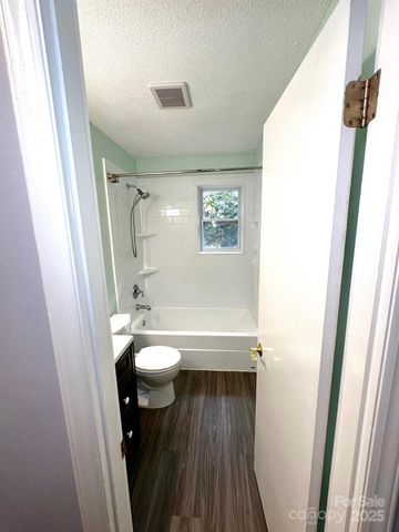 a bathroom with a sink a toilet a mirror and shower