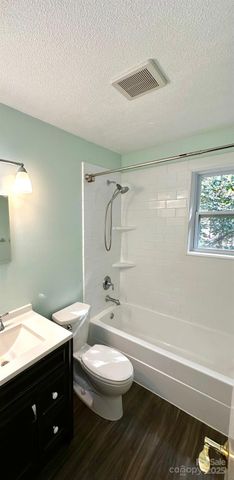 a bathroom with a double vanity sink toilet a shower and a bathtub