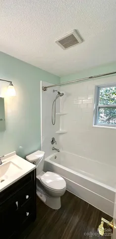 a bathroom with a double vanity sink toilet a shower and a bathtub
