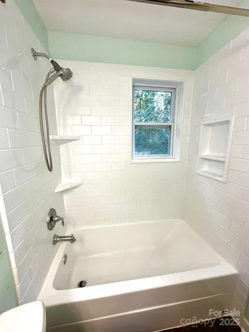 a bathroom with a bathtub and a shower