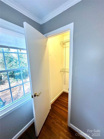 a view of empty room with wooden floor and walls