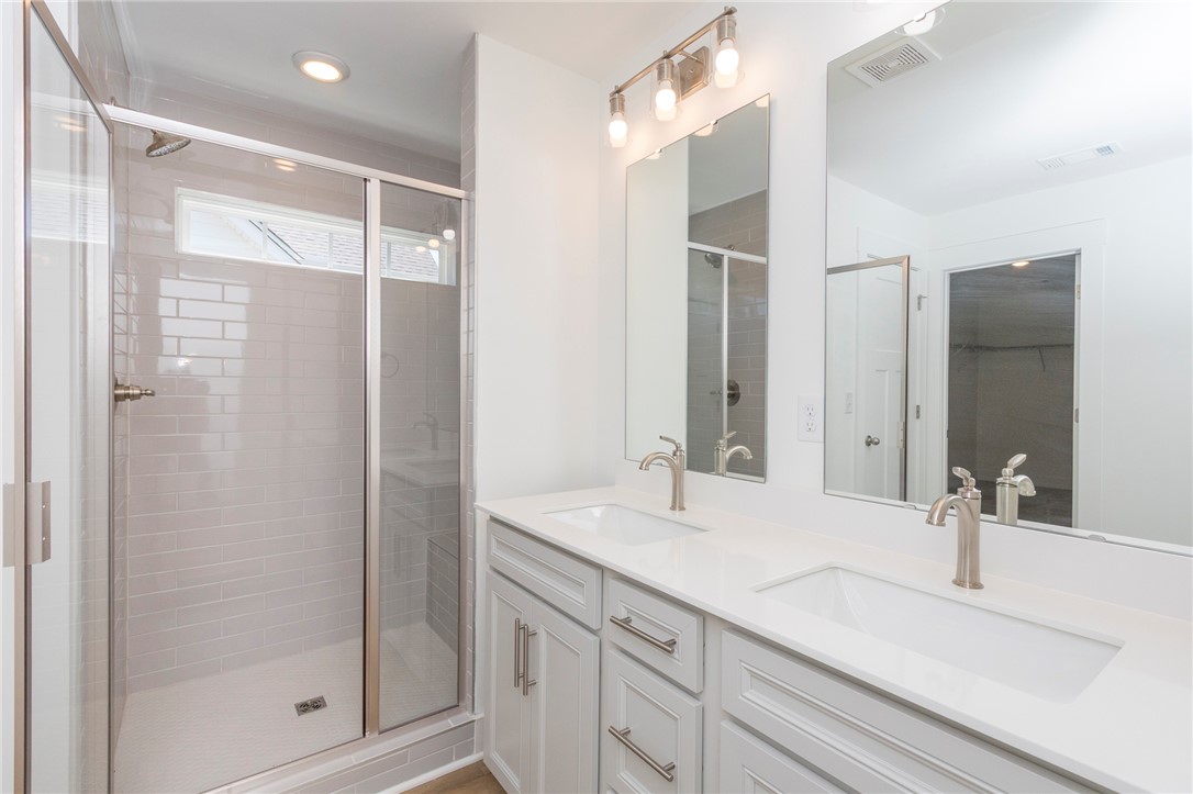 607 WH Kay Lane Anderson, SC 29621 - Photo 37 of 48 A well-appointed bathroom features a spacious walk-in shower and a double vanity.