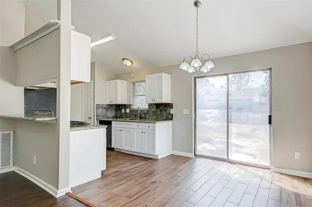 a kitchen with stainless steel appliances granite countertop a refrigerator a sink and a stove