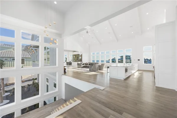 a large white kitchen with stainless steel appliances