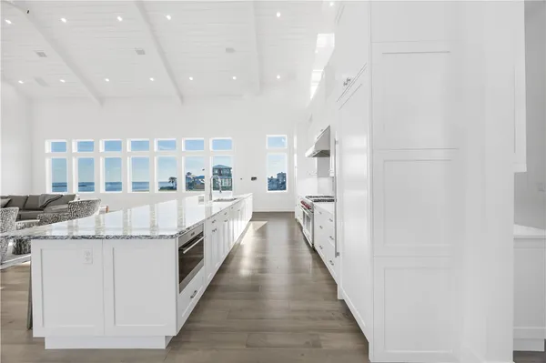 a large kitchen with kitchen island a large window
