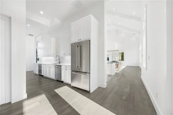 a kitchen with stainless steel appliances a refrigerator and a sink