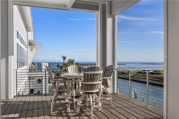 a balcony with table and chairs