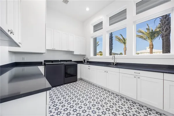 a kitchen with stainless steel appliances kitchen island granite countertop a sink and cabinets