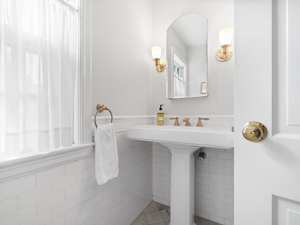 45 Cartwright Road Wellesley, MA 02482 - Photo 18 of 26 a bathroom with a sink a mirror and a window