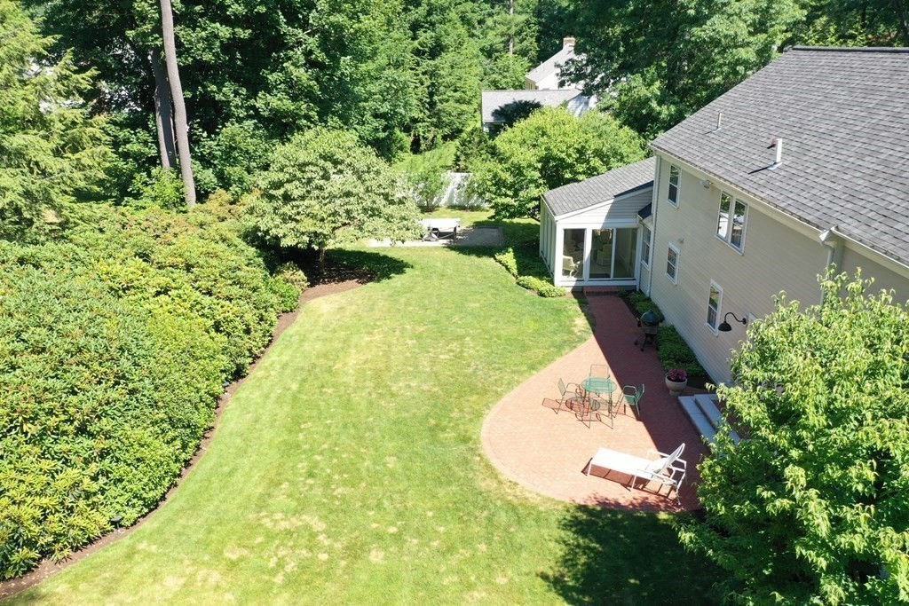45 Cartwright Road Wellesley, MA 02482 - Photo 25 of 26 a view of a house with a yard and potted plants