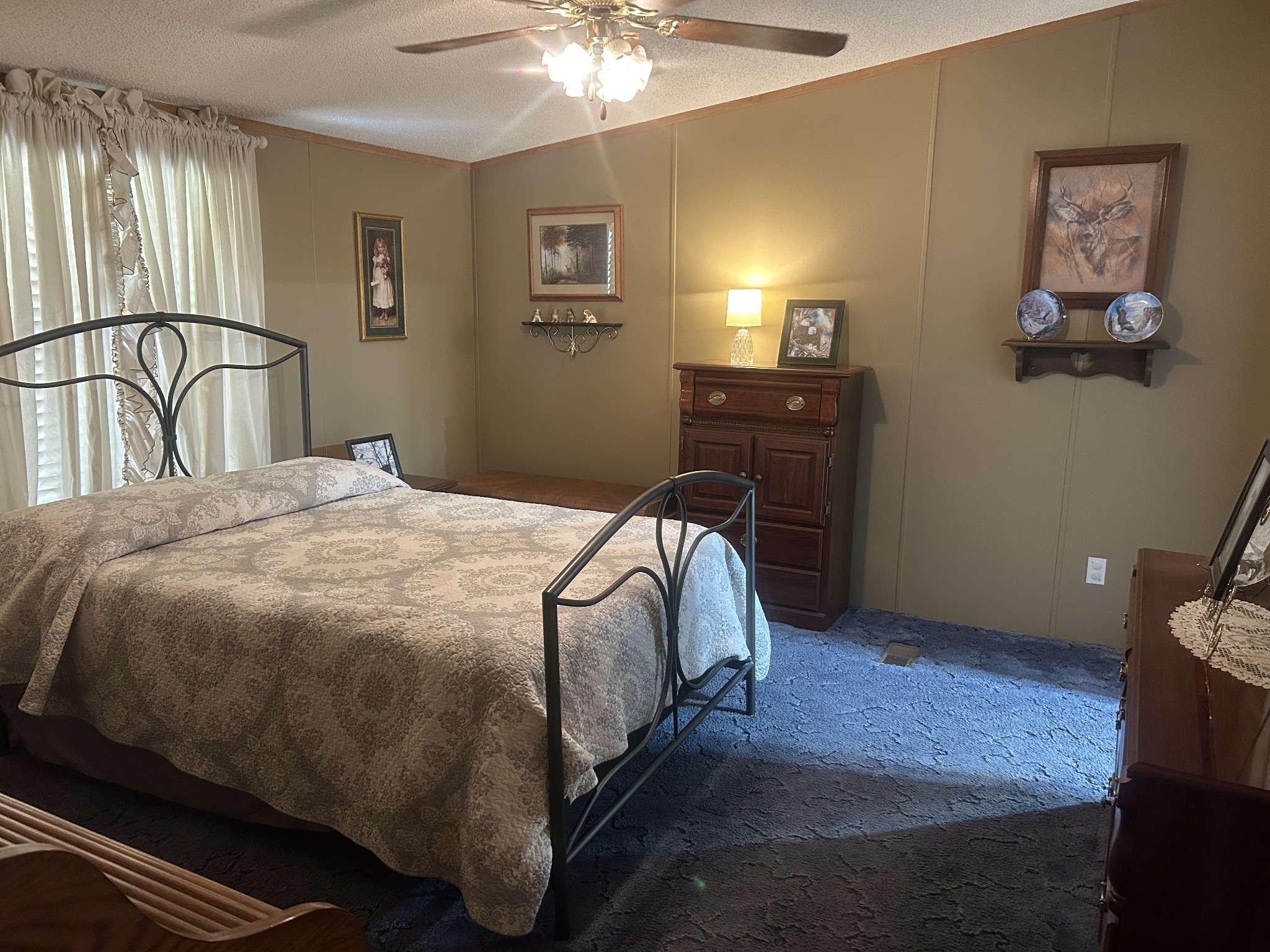 550 Sales Landing Road Camden, TN 38320 - Photo 22 of 27 a bedroom with a bed and a chandelier