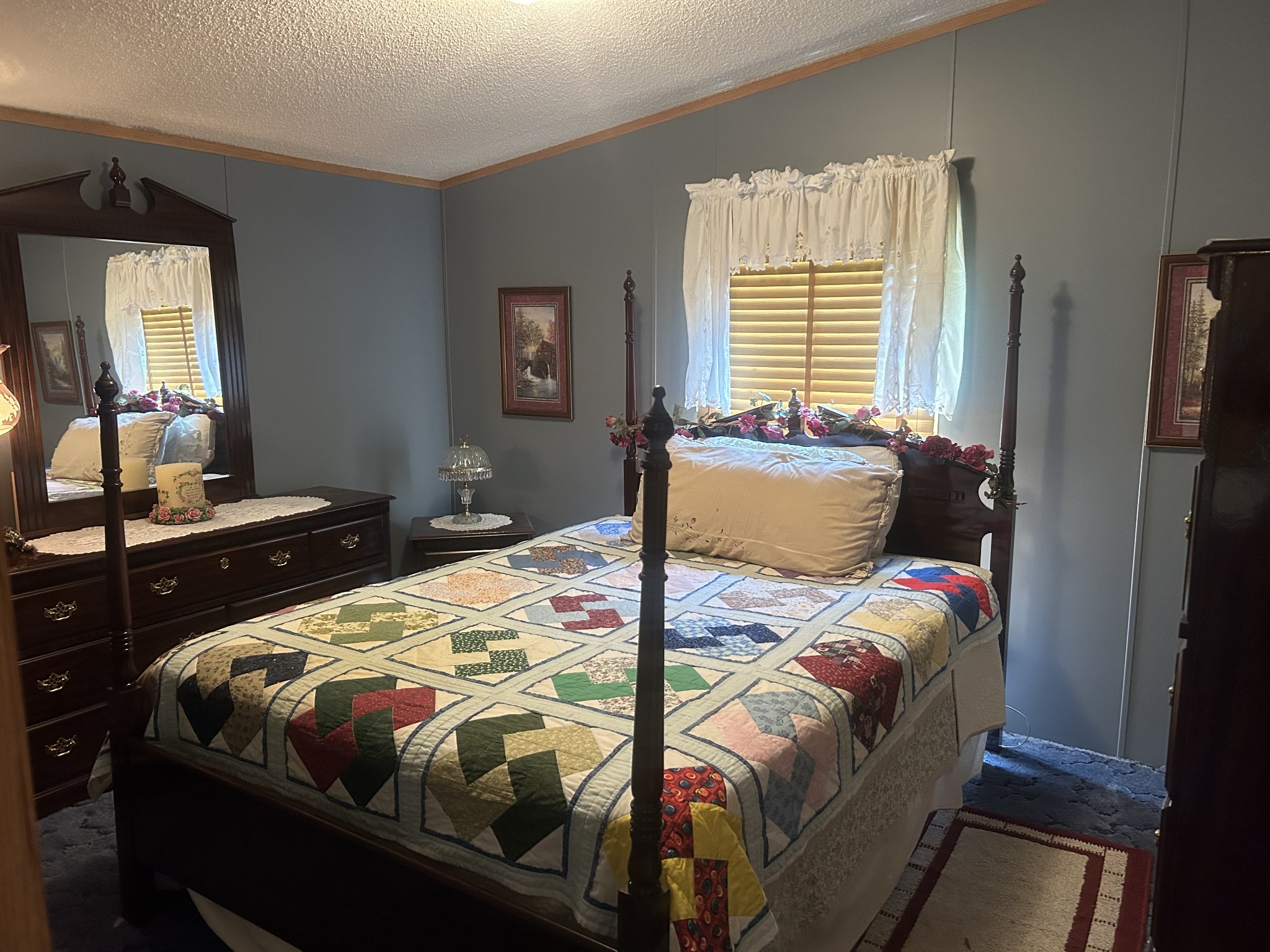 550 Sales Landing Road Camden, TN 38320 - Photo 25 of 27 a bedroom with a bed and a dresser in it