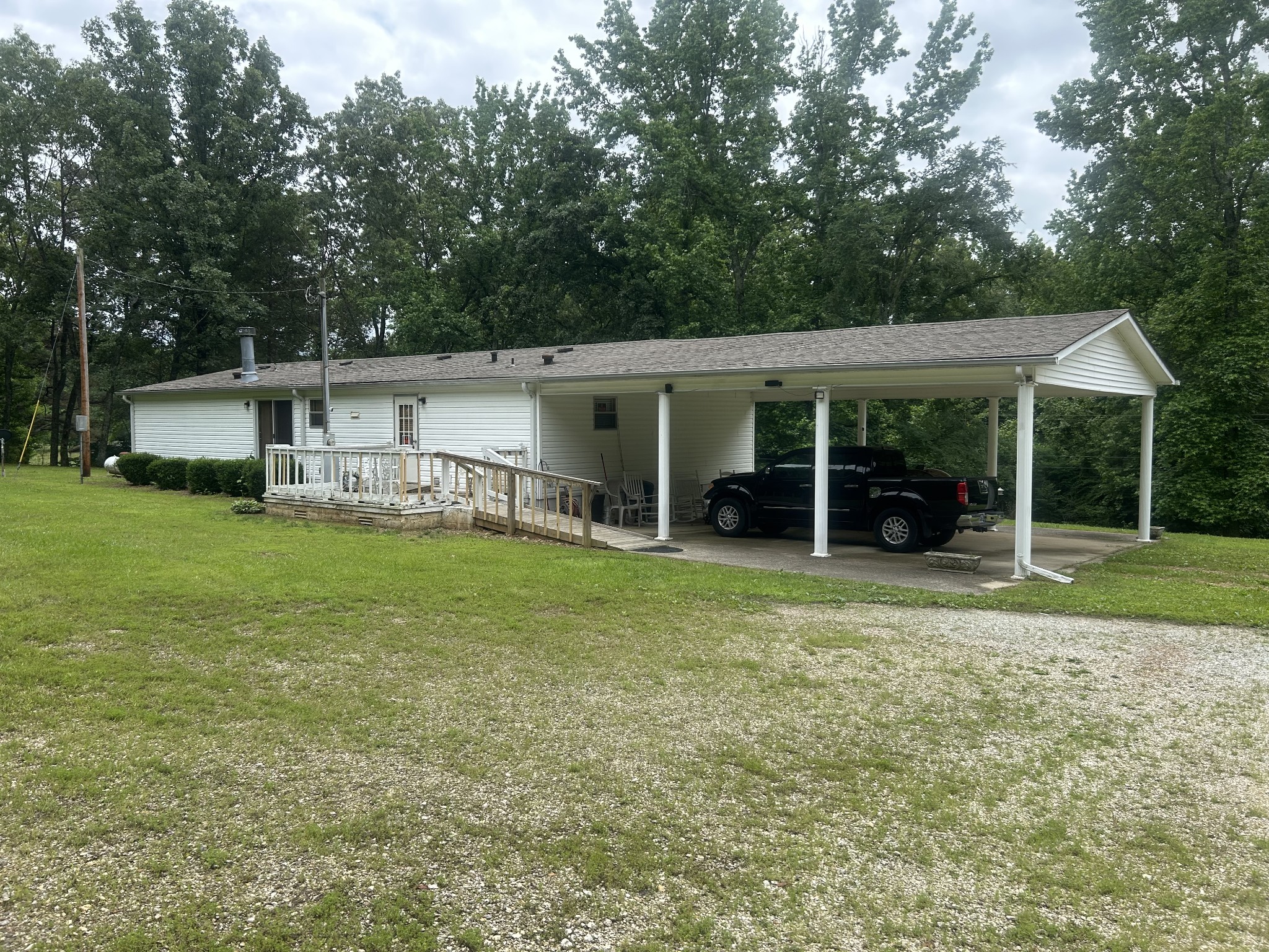 550 Sales Landing Road Camden, TN 38320 - Photo 8 of 27 a view of a house with backyard porch and sitting area