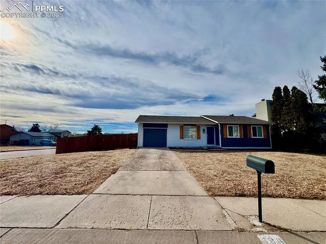 a view of a house with wooden fence