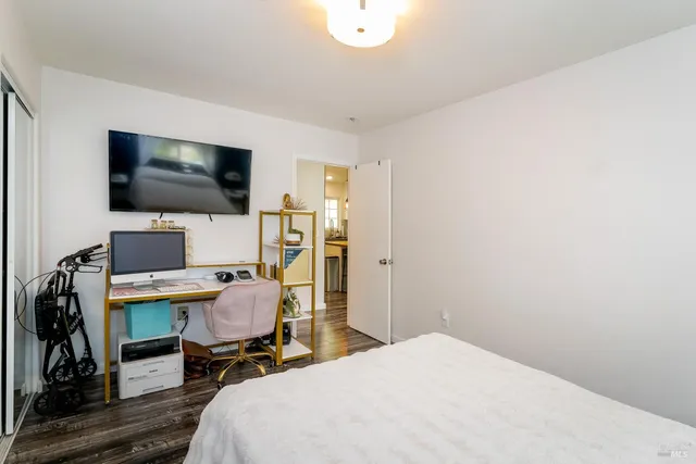 a bedroom with a workspace