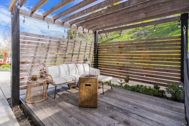 a view of a porch with furniture and wooden floor