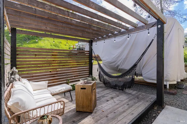 a backyard of a house with outdoor seating