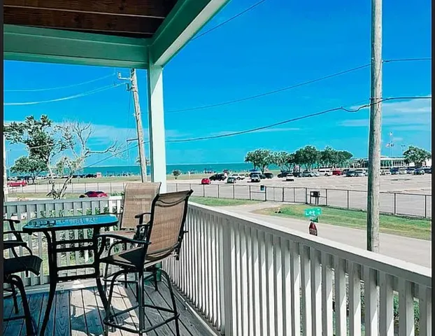 a view of a two chairs and table in the balcony