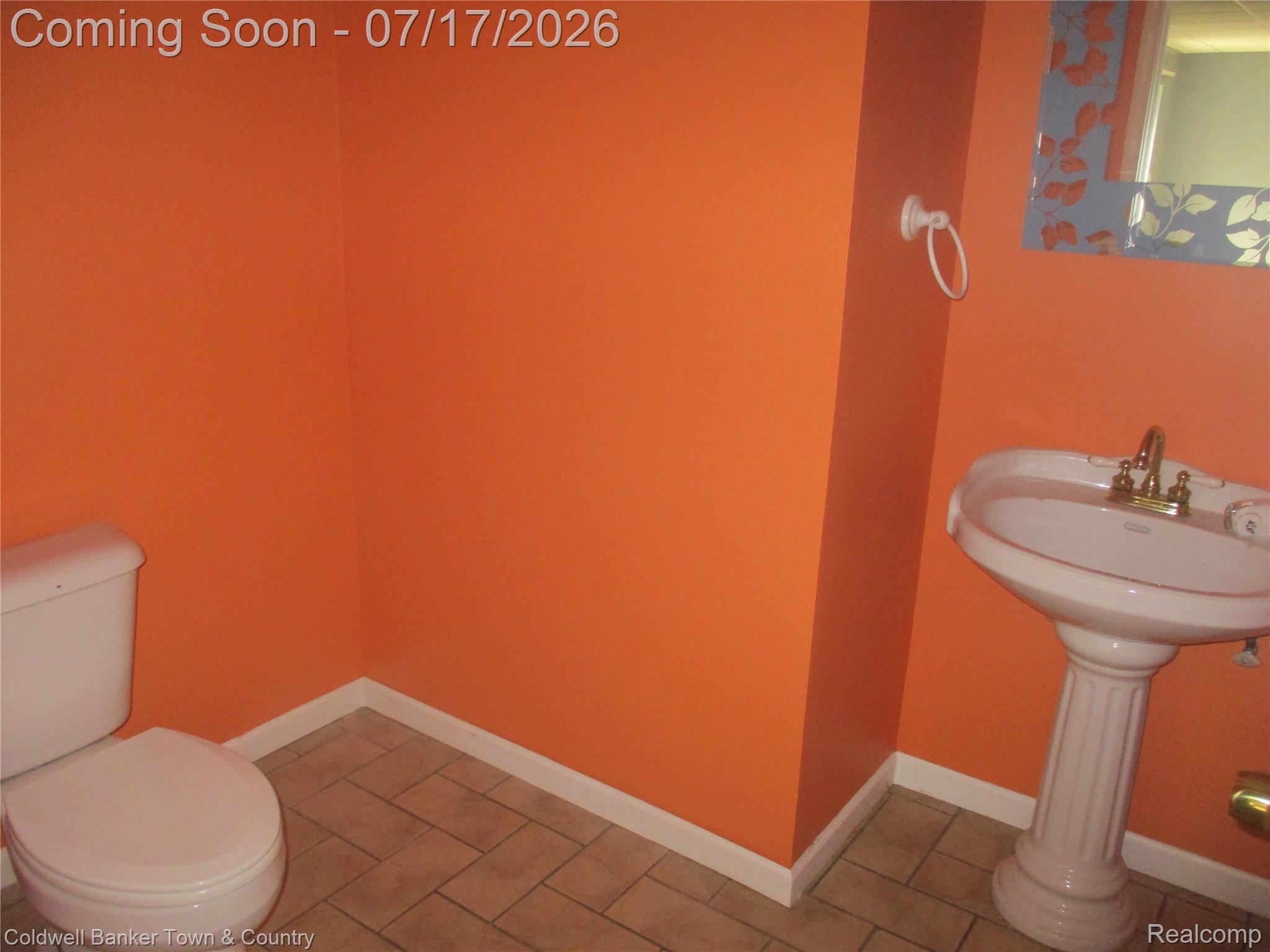 1996 Triangle Lake Road Howell, MI 48843 - Photo 18 of 32 Bathroom featuring a white pedestal sink with brass-finish fixtures, a white toilet, and ceramic floor tiles